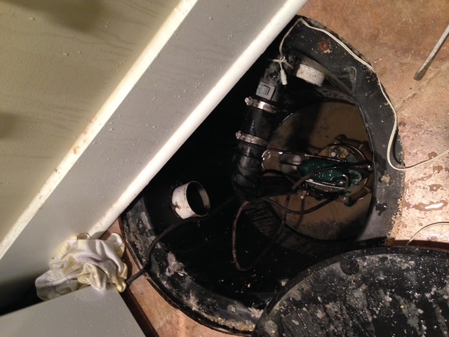 Exposed sump pump showing the need for repair